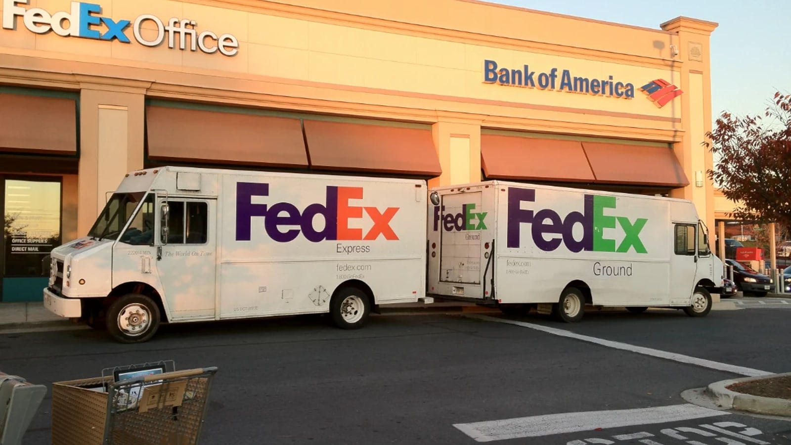 Historical FedEx Express and Ground vehicles outside a FedEx Office location.