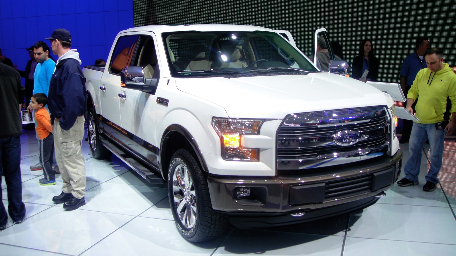 White Ford F-150 pickup displayed at an auto show.