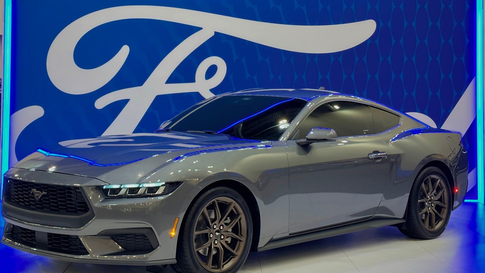 Seventh-generation Ford Mustang displayed in front of a blue Ford script wall.