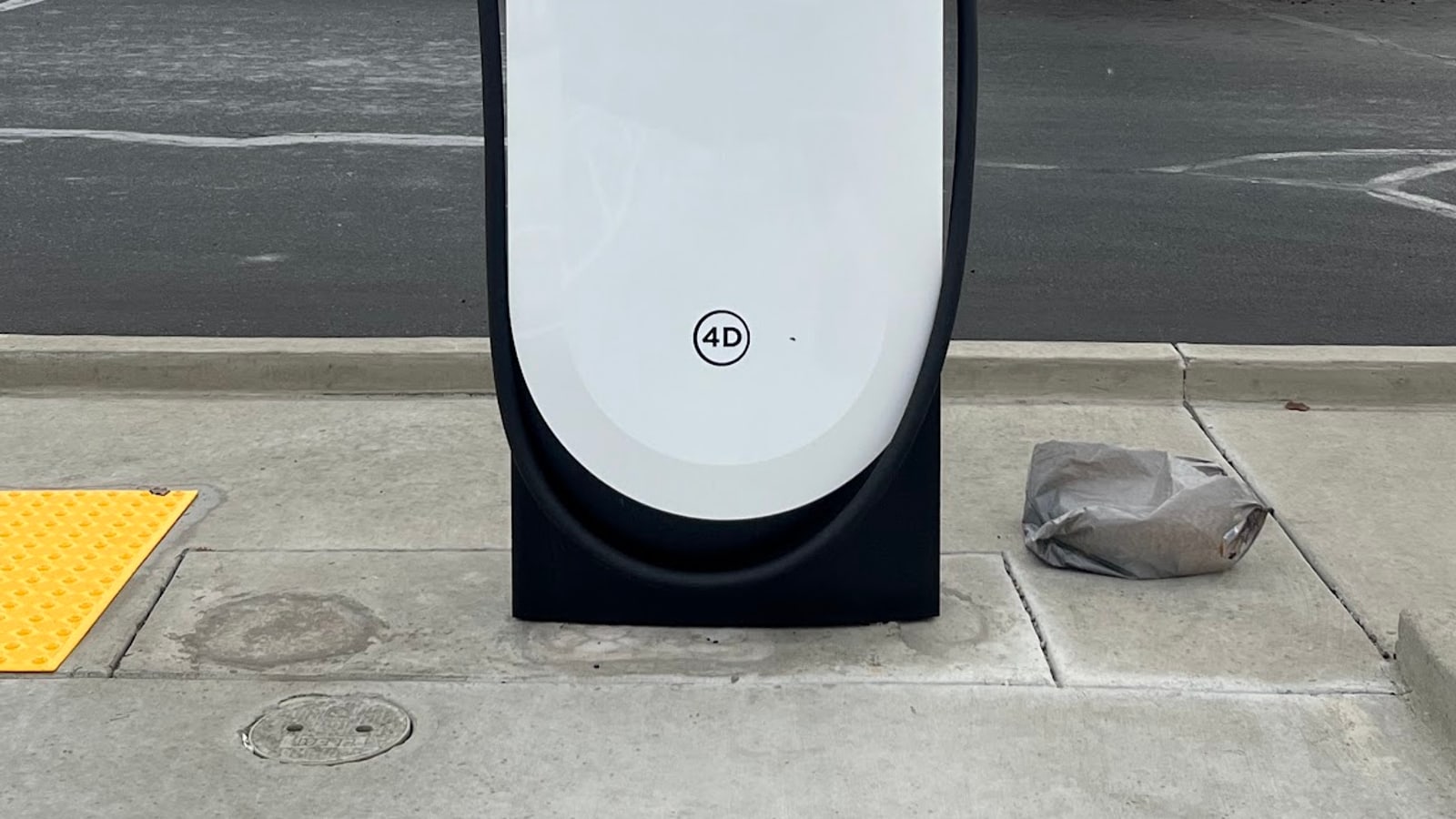 Tesla V4 Supercharger post at a public charging site.