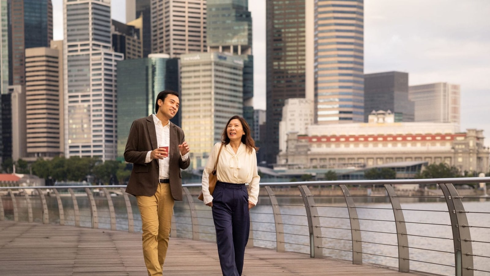 Two UBS wealth-management clients walking in a financial district.