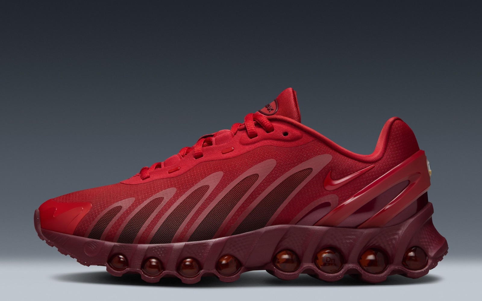 Official Nike Air Max Dn8 product image showing the red silhouette and visible Dynamic Air cushioning.