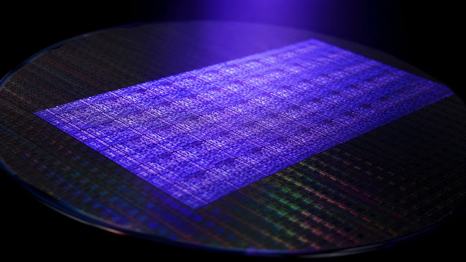 A declared conceptual macro view of a silicon wafer under a controlled violet-blue exposure field.