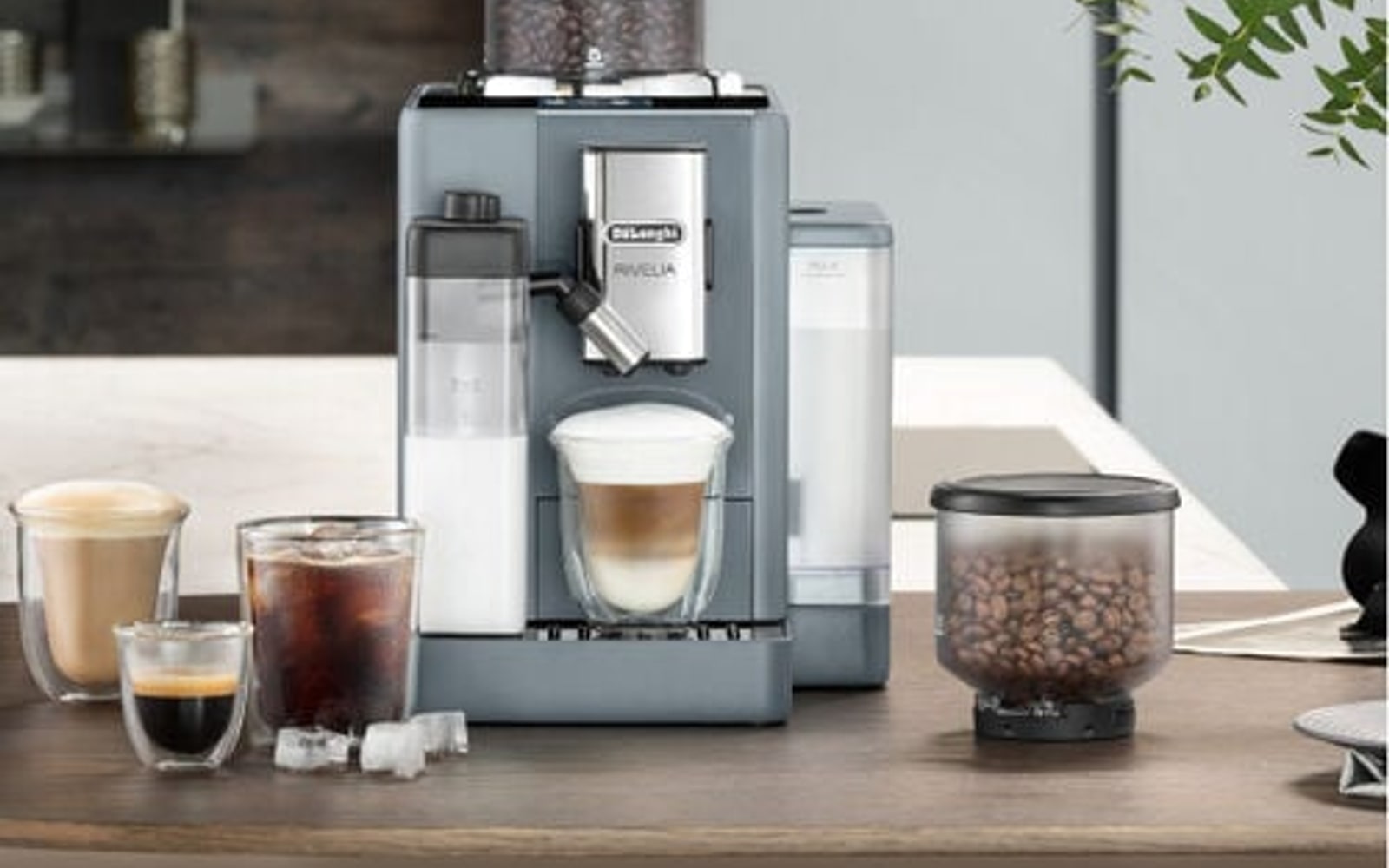 De’Longhi espresso machine with coffee cups and kitchen counter setting.