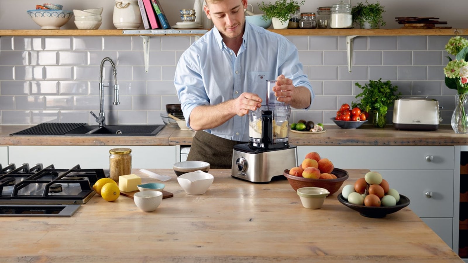 Kenwood food processor being used in a kitchen.