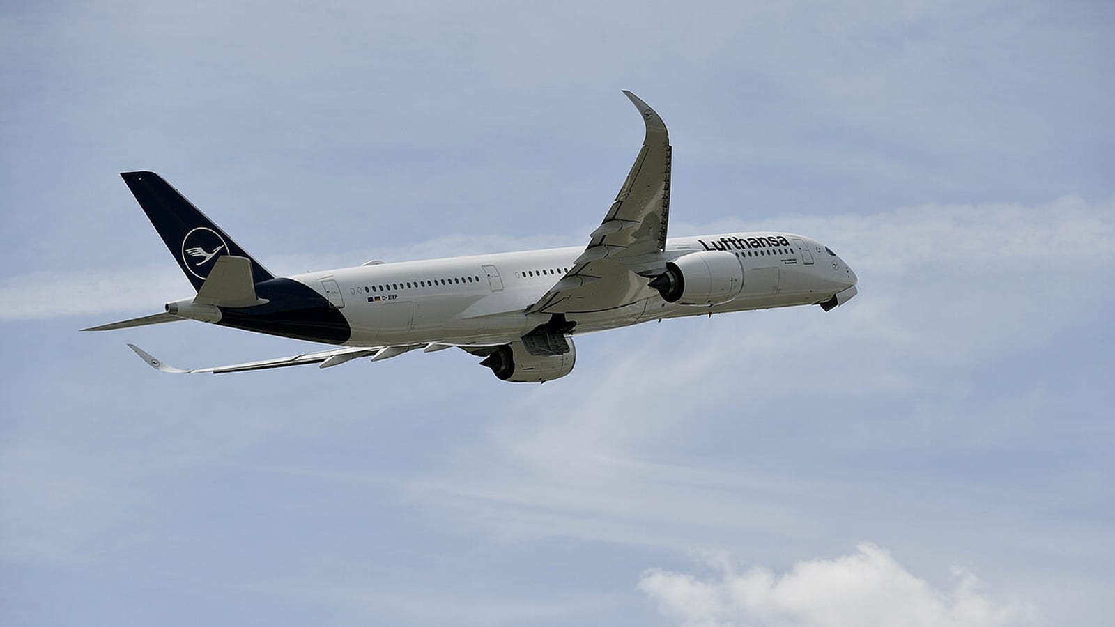 Official Lufthansa Airbus A350 in flight with the verified navy crane tail and fuselage wordmark.