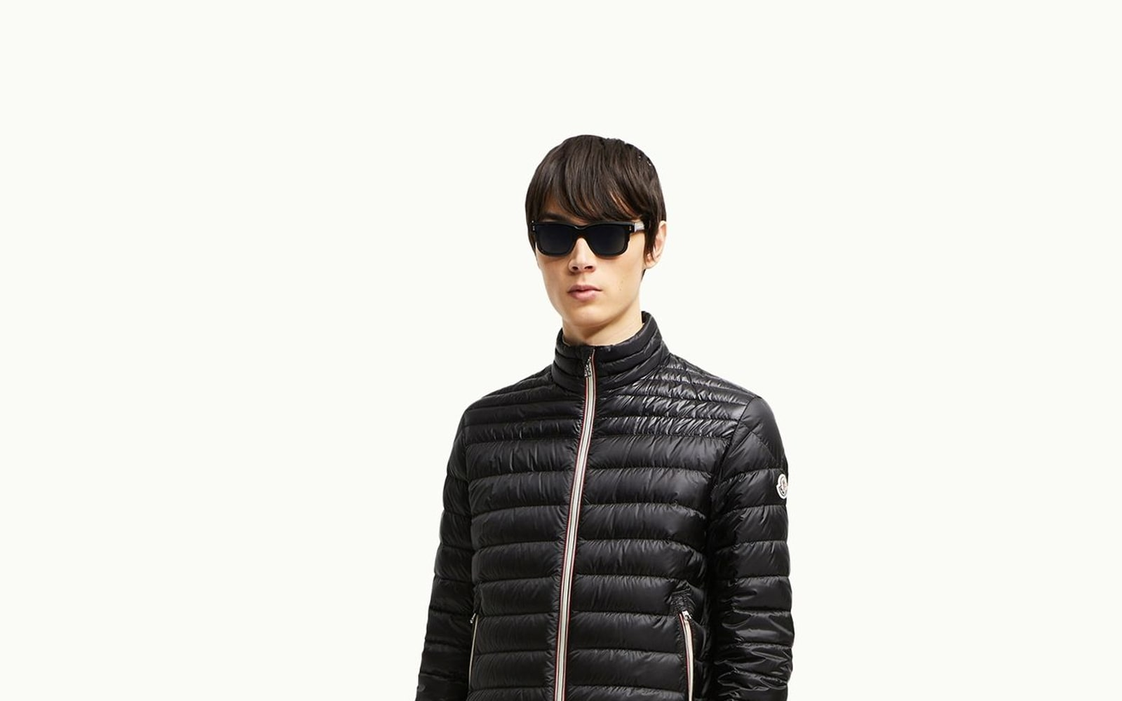 Moncler-style luxury down outerwear in a winter editorial setting.