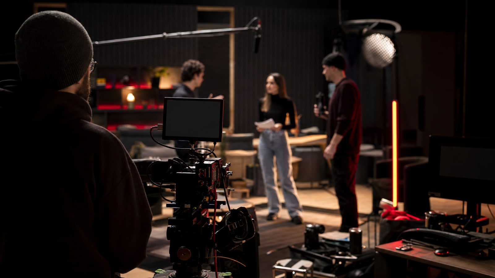 Netflix production set with camera, crew, and red-black studio lighting.