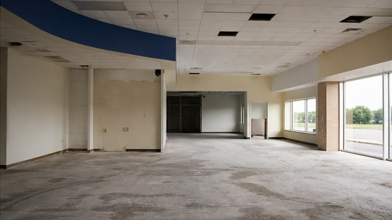 An emptied former pharmacy retail shell after fixtures were removed.