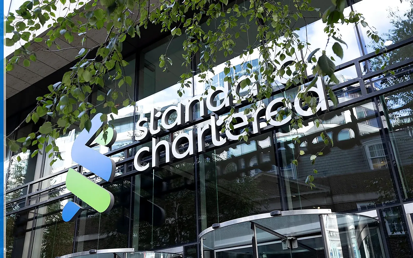 Standard Chartered banking service scene with the source-backed mark in a real-world financial setting.