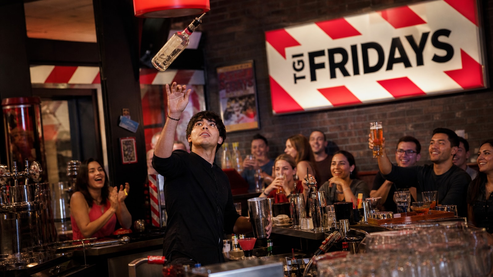 TGI Fridays bartender performing a controlled flair move before celebrating guests.