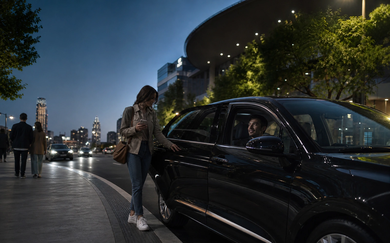 Rider meeting a driver beside a black vehicle during an evening city pickup.