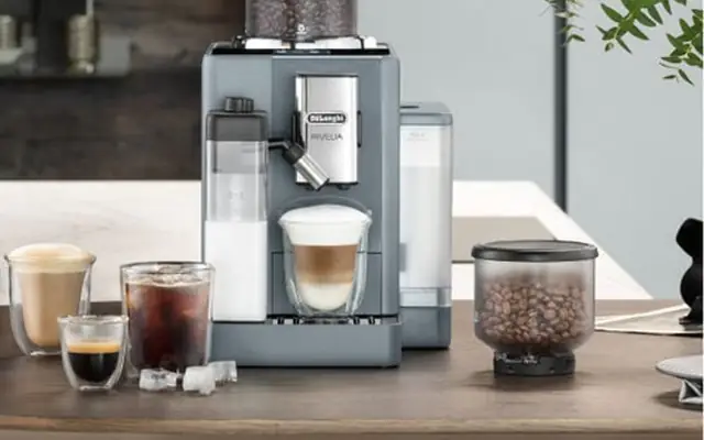 DeLonghi espresso machine with coffee cups and kitchen counter setting.