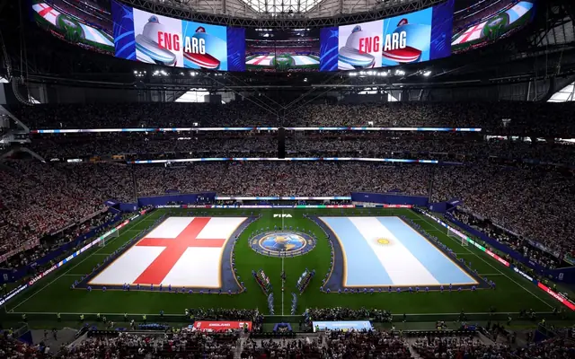 A packed Atlanta stadium before the England versus Argentina 2026 FIFA World Cup semi-final, with FIFA tournament branding visible around the pitch.