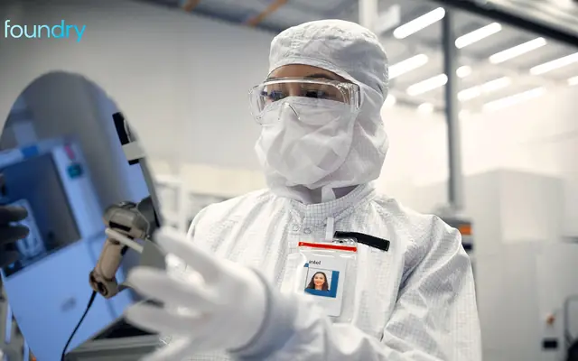 Official Intel Foundry image with engineer in fab cleanroom.