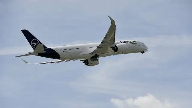 Official Lufthansa Airbus A350 in flight with the verified navy crane tail and fuselage wordmark.