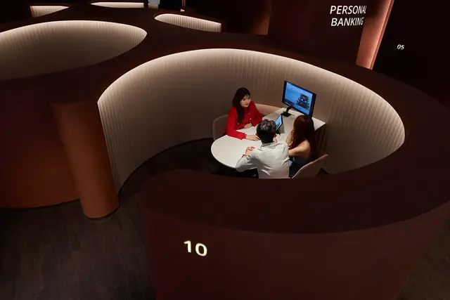 Customers meeting an adviser inside OCBC's Wisma Atria personal-banking space in Singapore.