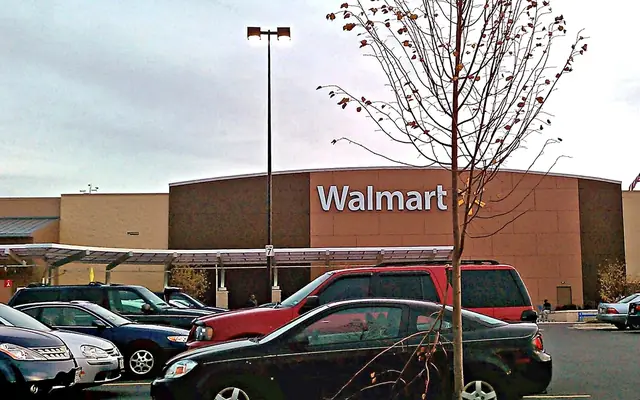 Walmart Supercenter frontage with the blue Walmart sign and large-format retail scale visible.